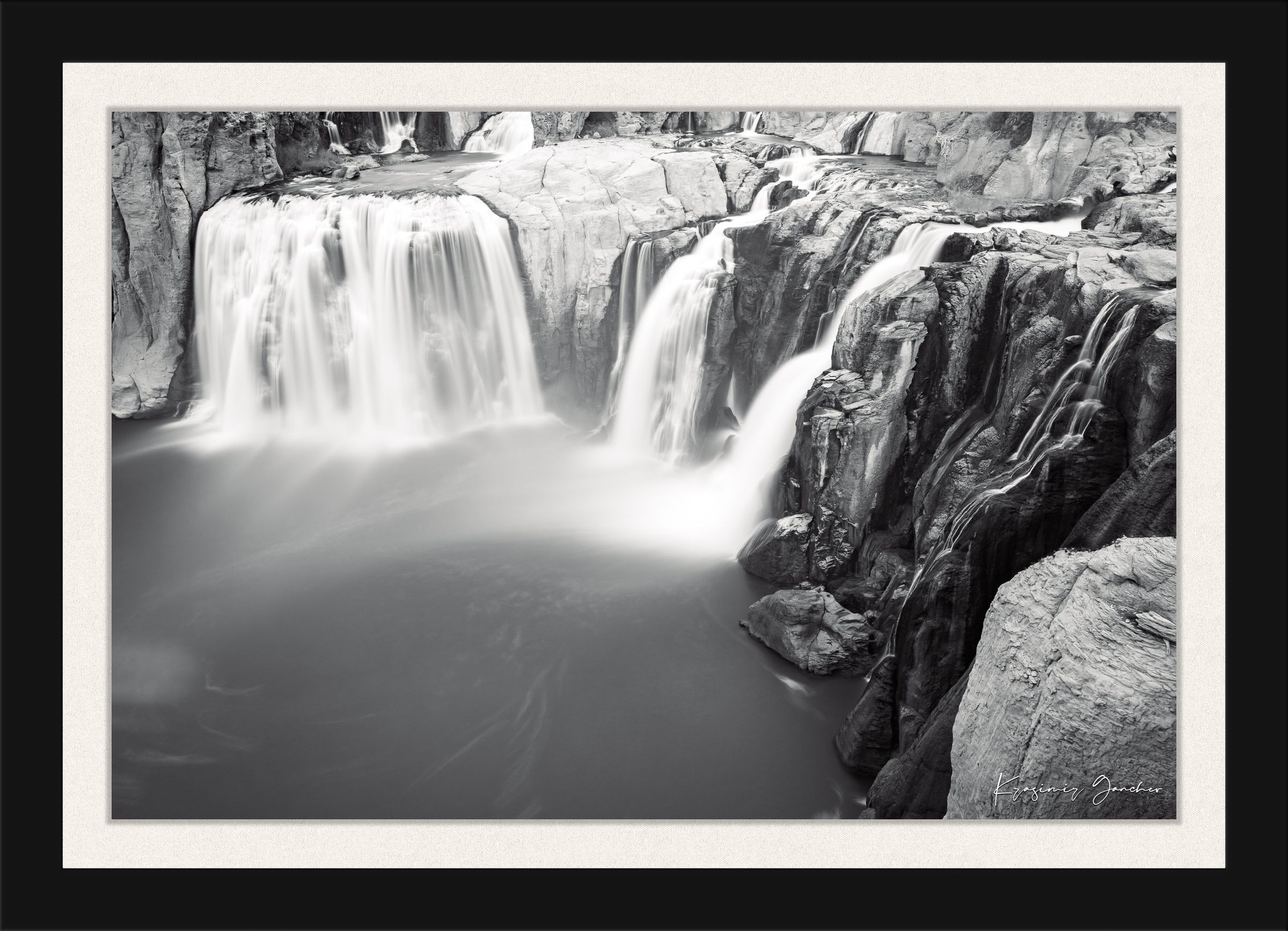 Black and white photograph of a powerful Shoshone Falls waterfall cascading into dark recesses with blurred water motion. #Finish_Roma Satin Black Frame & Bright Liner