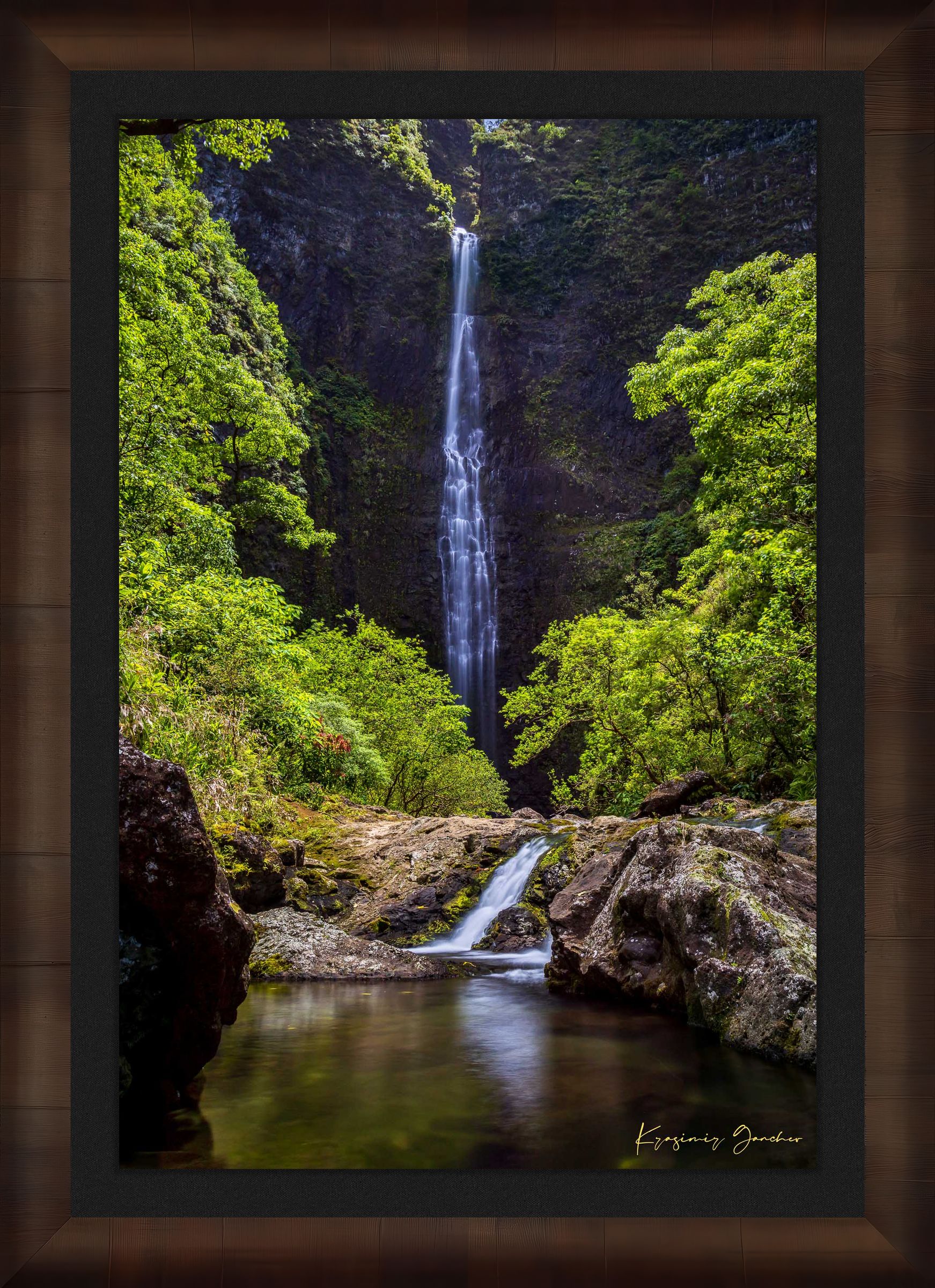 Small waterfall veiled in mist beneath dense foliage at Hanakapiai Falls, Kauai, lit by daylight. #Finish_Roma Cigar Leaf Frame & Dark Liner