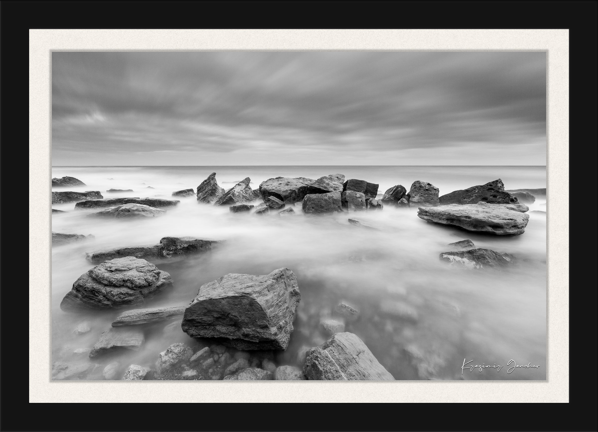 Coastal rock and sand landscape at Fichoza, Bulgaria captured in monochrome during daylight under cloudy skies. #Finish_Roma Satin Black Frame & Bright Liner