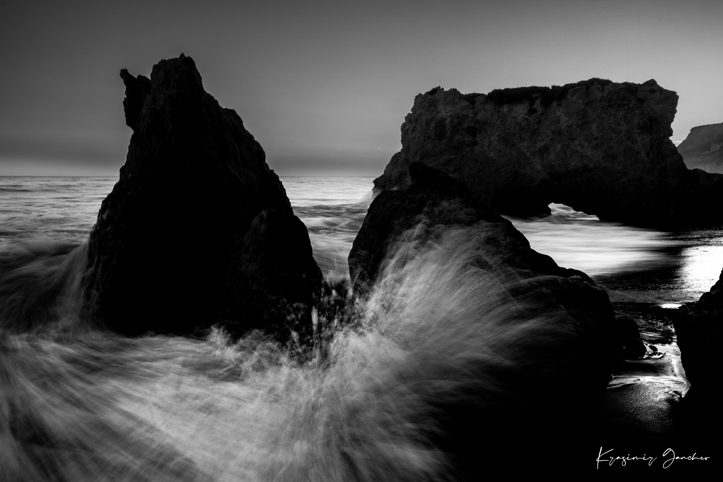 Rock arch formation along the coastal ocean at El Matador Beach, Malibu, California, with crashing waves and dusky atmosphere. #Finish_Acrylic Recess