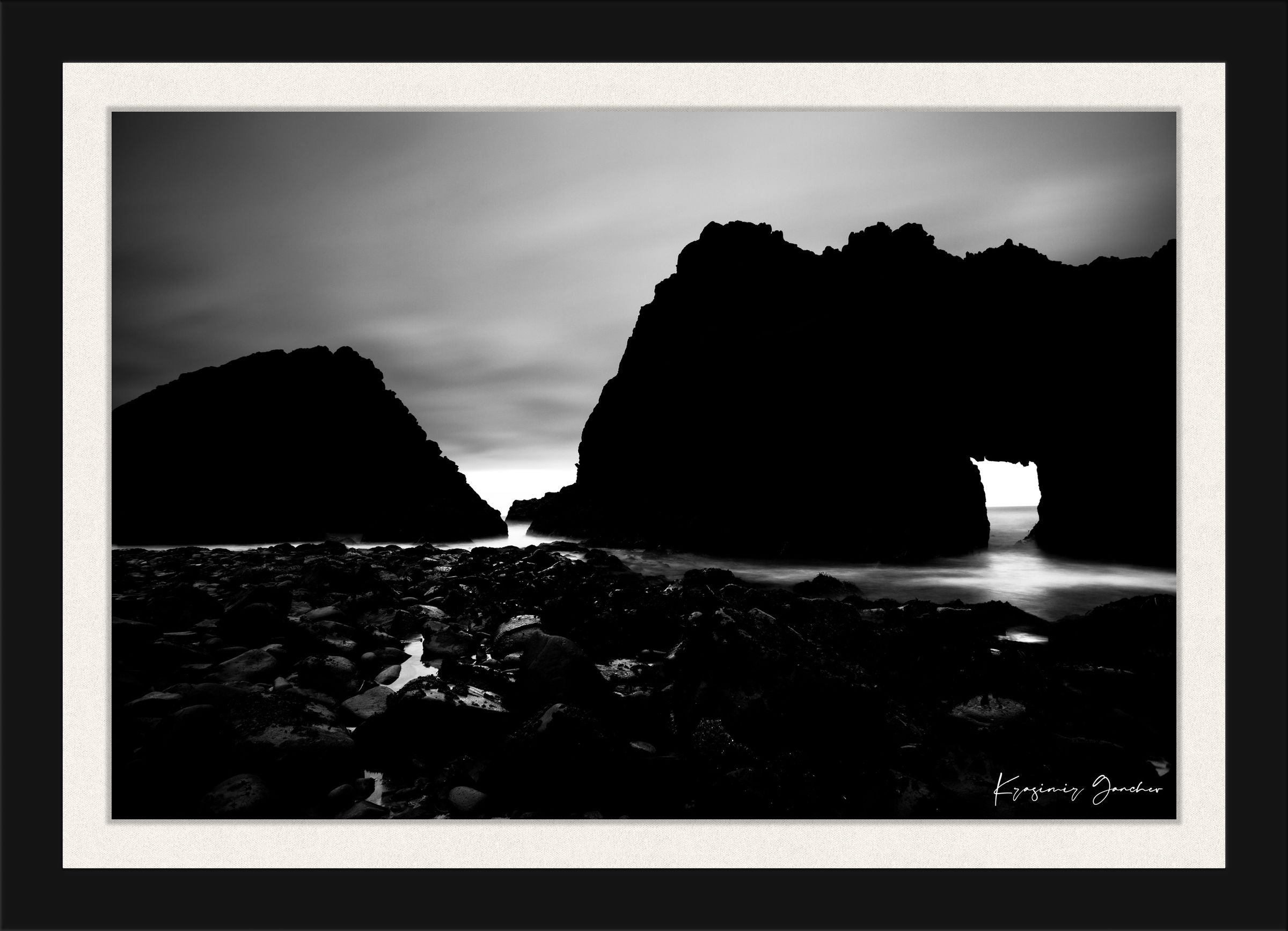 Silhouette of Keyhole Arch at Big Sur under dusky sky with cloud and wave detail. #Finish_Roma Satin Black Frame & Bright Liner