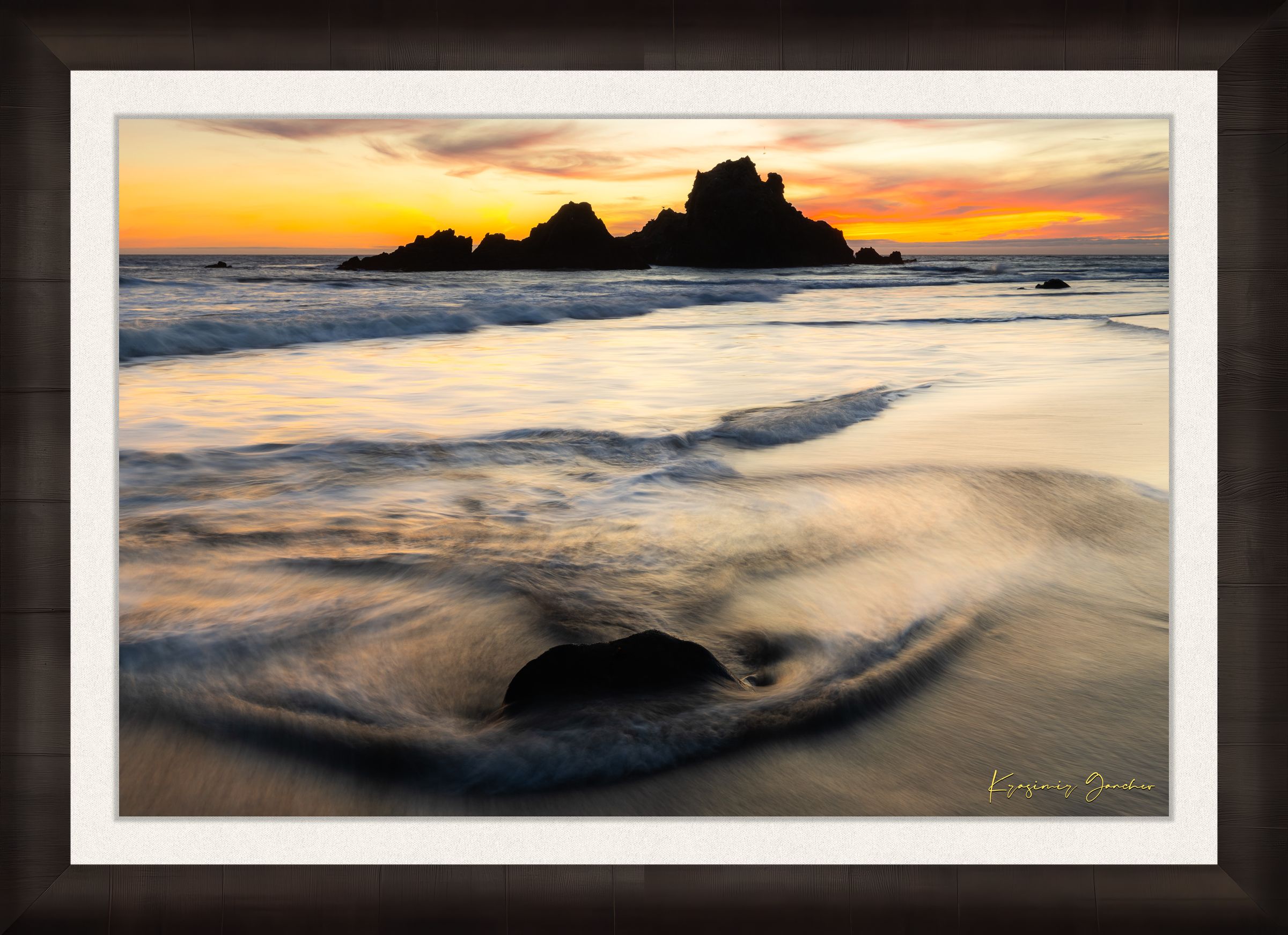 Beach scene at Pfeiffer Beach in Big Sur featuring sea stack, golden hour light, clouds, and gentle rolling waves. #Finish_Roma Dark Ash Frame & Bright Liner