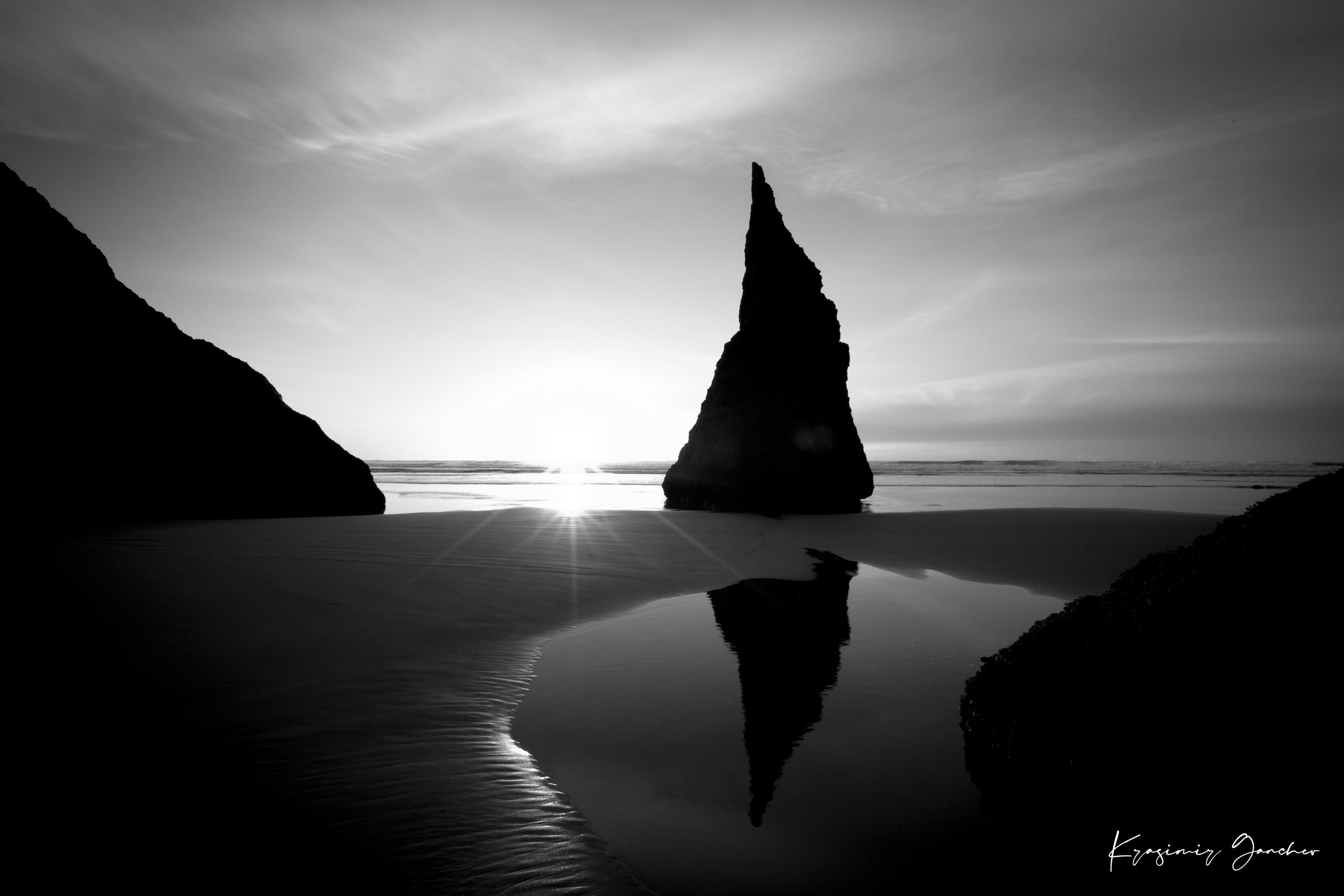 Black and white photograph of the Wizards Hat sea stack at Bandon Beach under hazy sunlight with clouds and ocean reflections. #Finish_Acrylic Recess