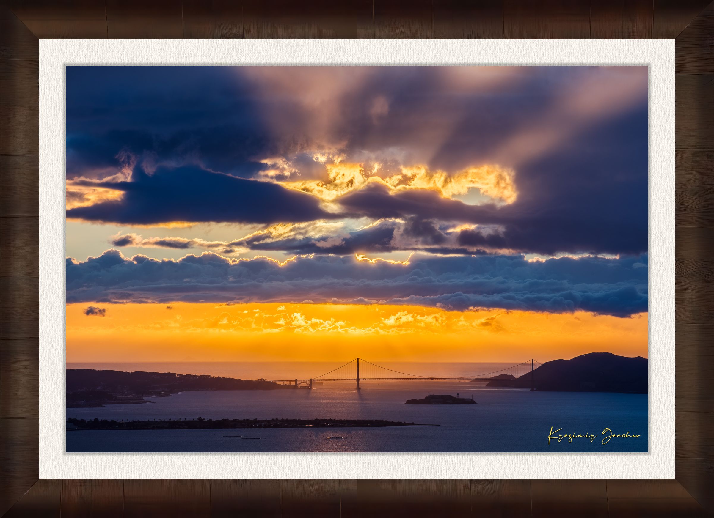 Golden Gate Bridge spanning a sunlit bay at sunset under layered stormy clouds, warm hues blending into cool sky tones. #Finish_Roma Cigar Leaf Frame & Bright Liner