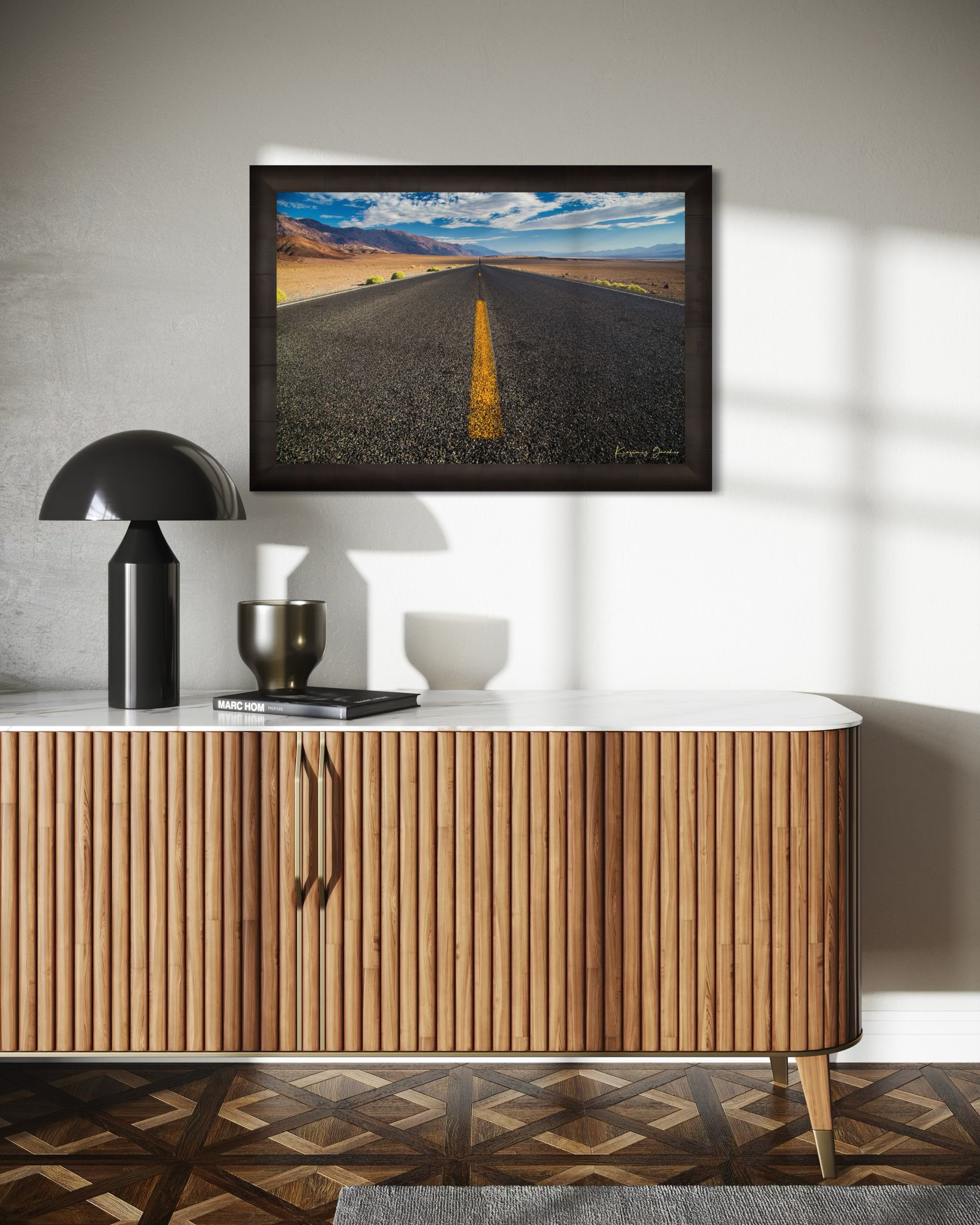 Straight desert road stretching into an open landscape of arid terrain in Death Valley National Park under overcast skies. #Finish_Roma Dark Ash Frame