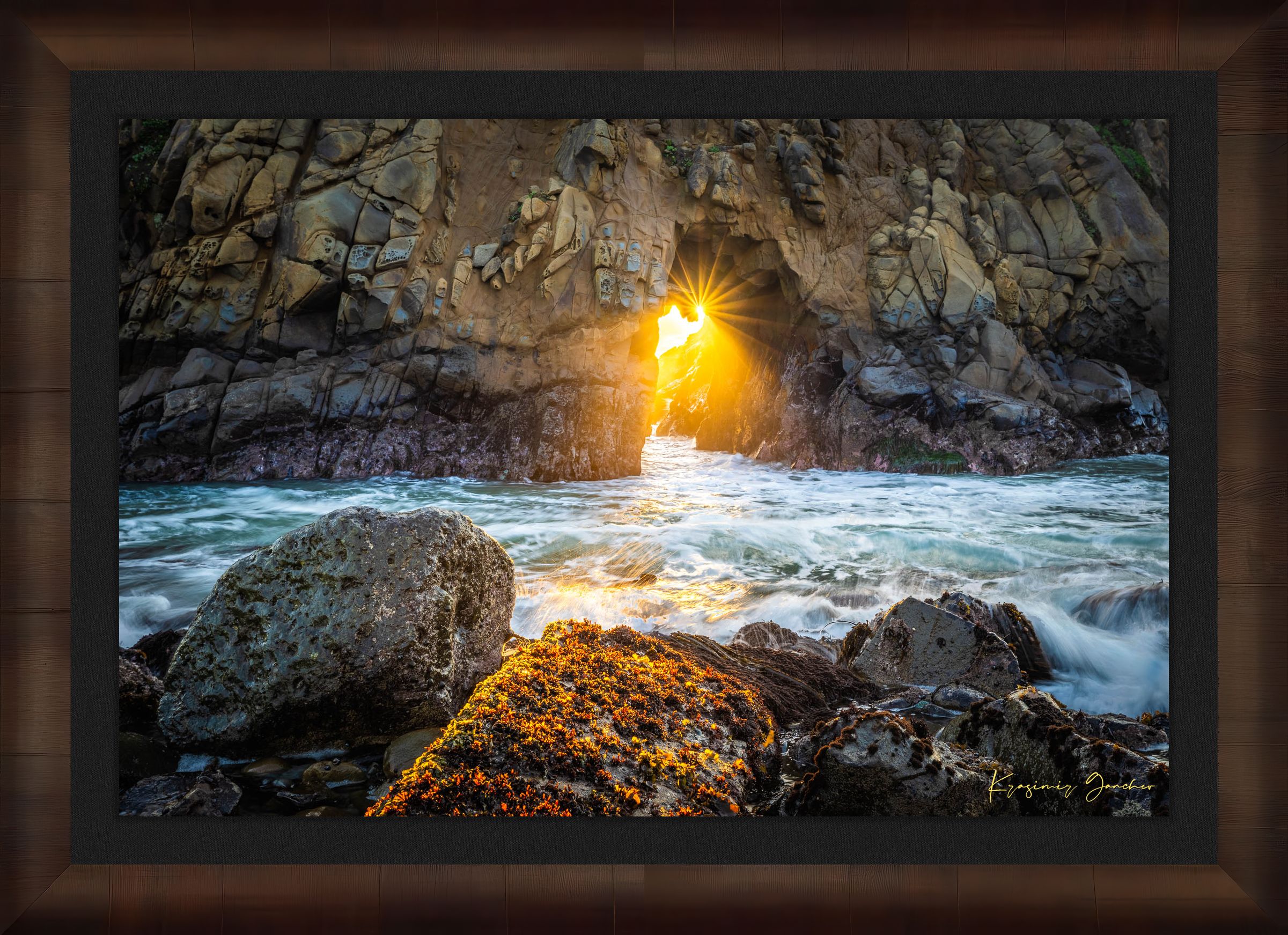 Golden-hour photograph of a coastal arch formed by erosion at Big Sur's rugged shoreline, featuring boulders and open sea. #Finish_Roma Cigar Leaf Frame & Dark Liner