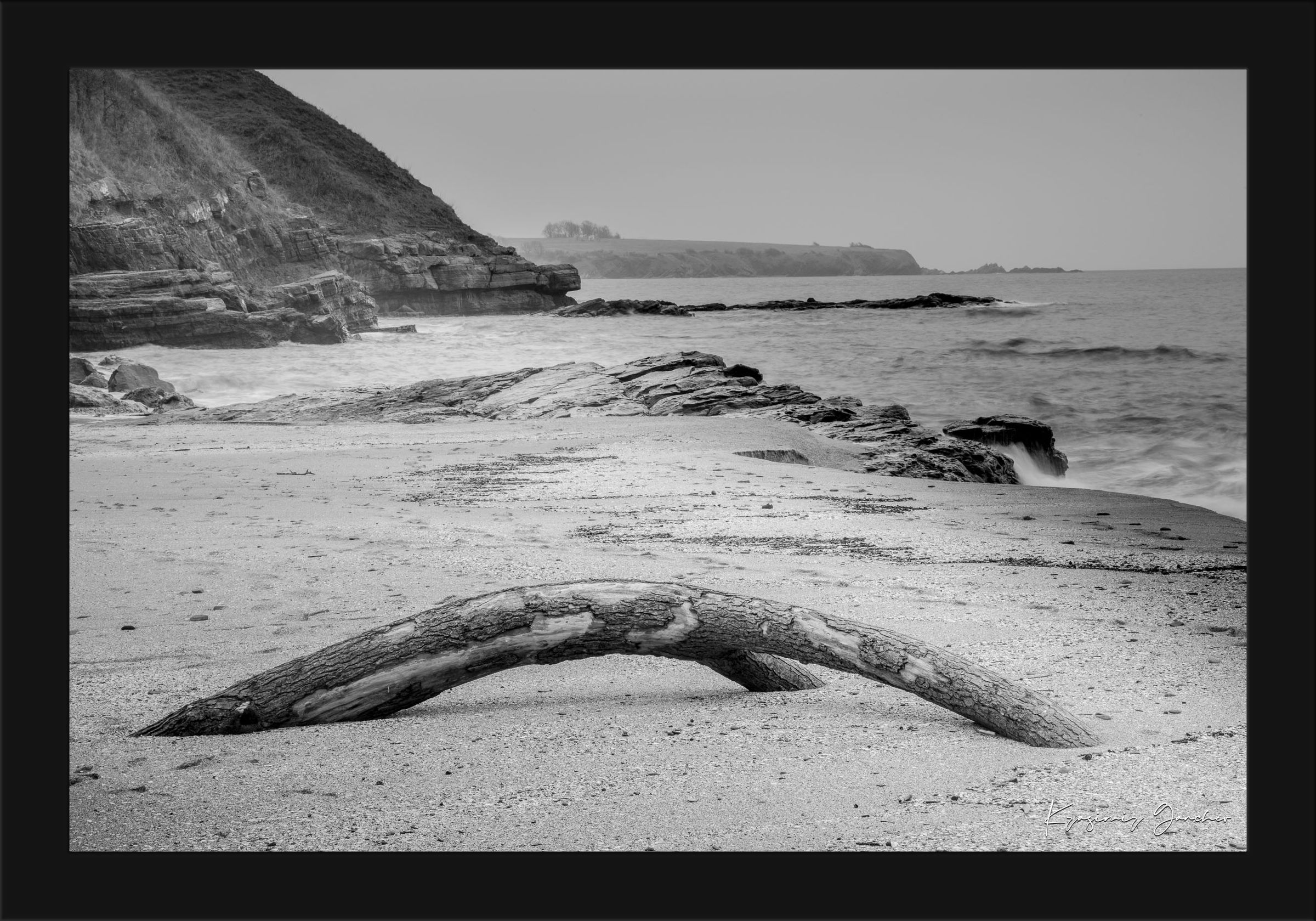 Weathered driftwood on Ahtopol beach along the Black Sea during daylight with haze. #Finish_Roma Satin Black Frame