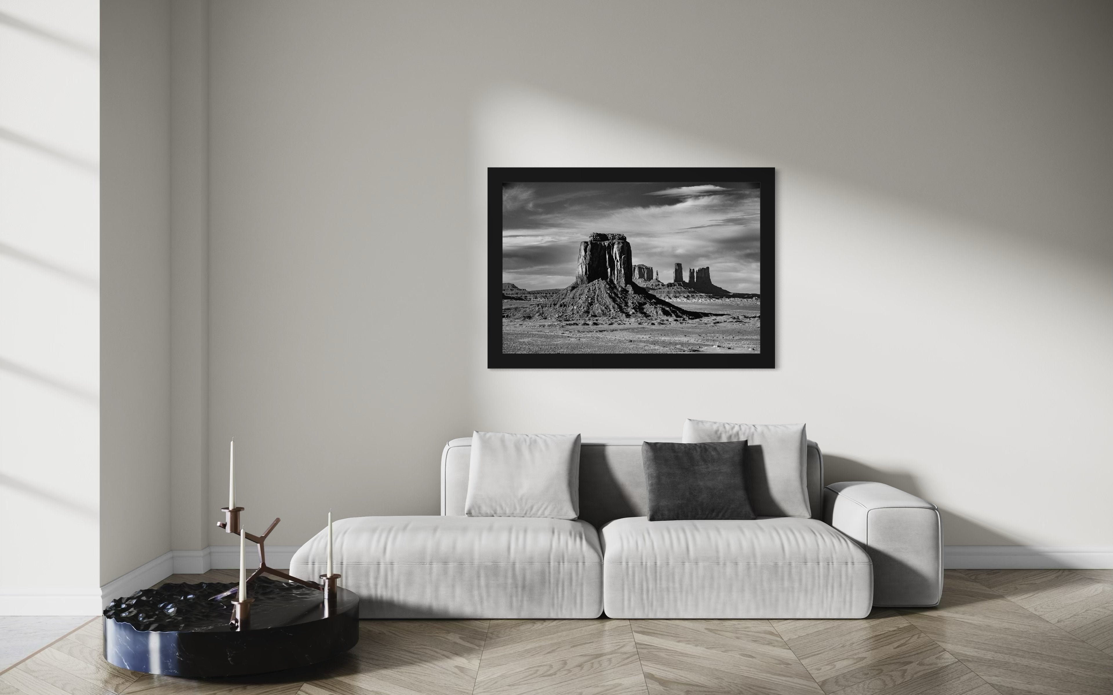 Timeless black and white landscape of Monument Valley's towering formations under dawn skies with soft cloud cover. #Finish_Roma Satin Black Frame