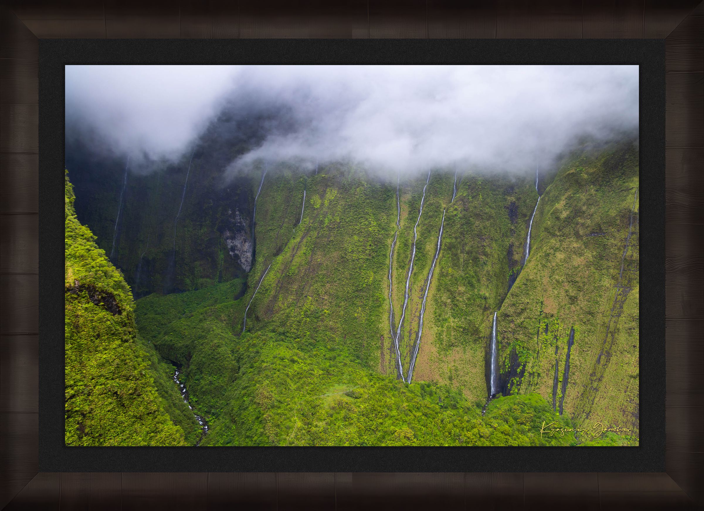 Multiple cascading waterfalls descending a cliff face in the Weeping Wall region, Kauai, during daylight under cloud cover. #Finish_Roma Dark Ash Frame & Dark Liner