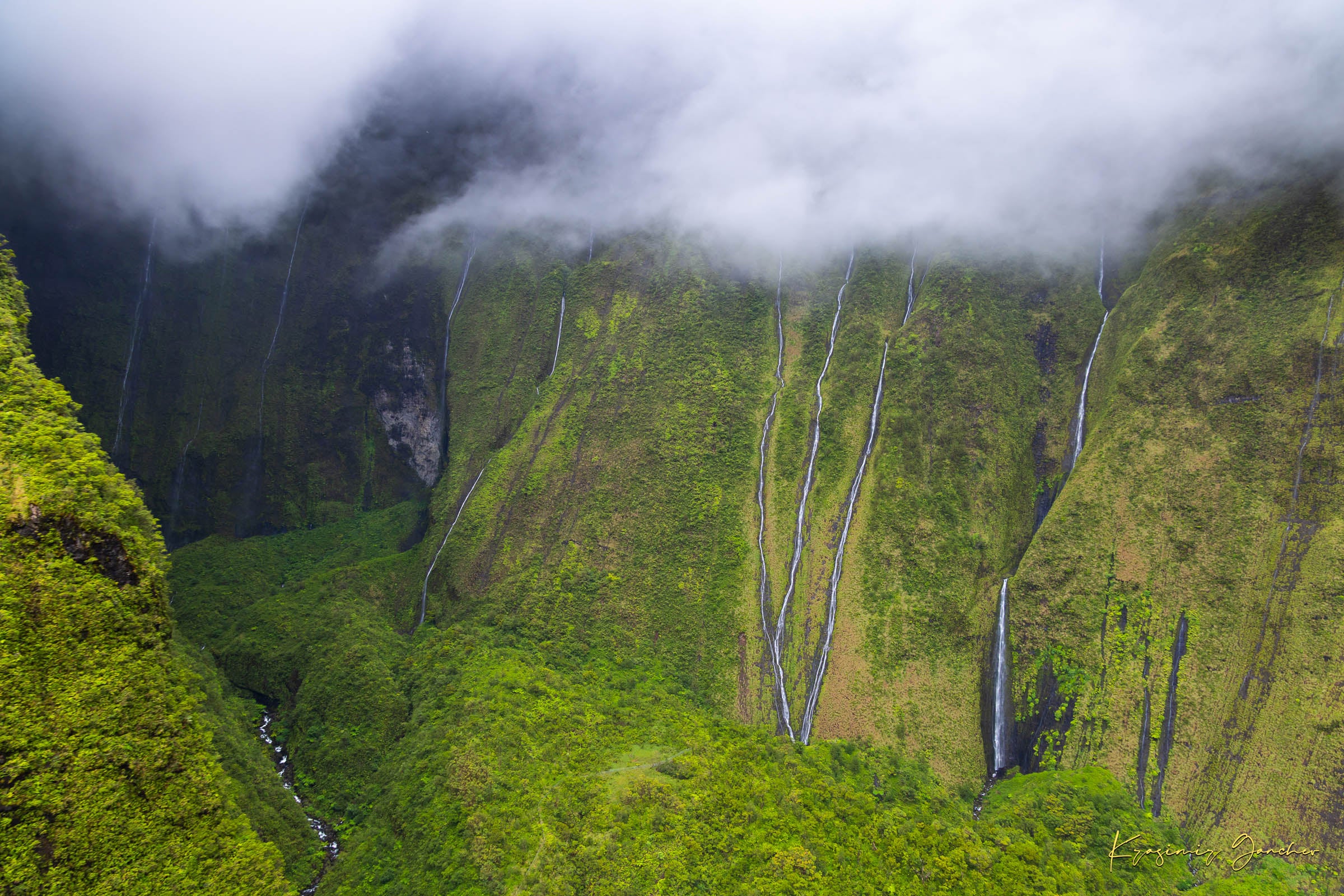 Multiple cascading waterfalls descending a cliff face in the Weeping Wall region, Kauai, during daylight under cloud cover. #Finish_Acrylic Recess