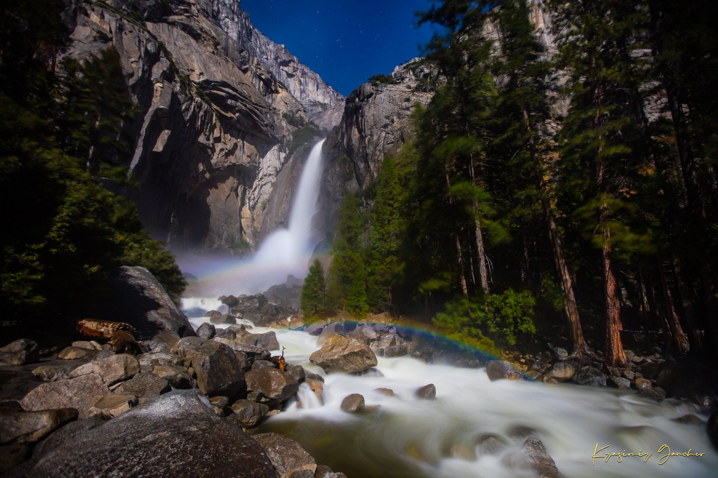 Yosemite Falls illuminated by starlight and an arc of moonbow, long exposure capturing flowing water against a clouded sky. #Finish_Acrylic Recess
